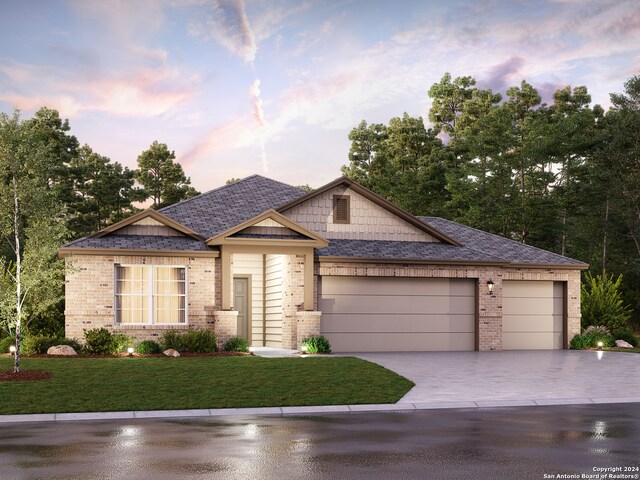 craftsman-style house with a garage and a lawn