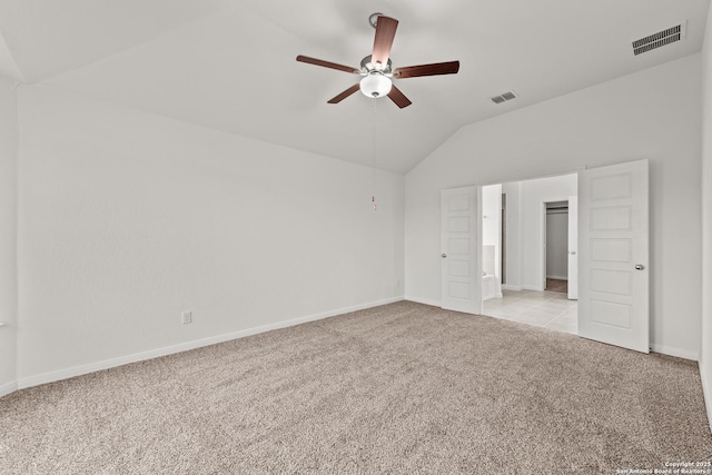 unfurnished bedroom with light carpet, vaulted ceiling, and ceiling fan