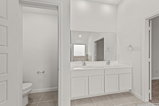 bathroom featuring vanity, toilet, and tile patterned flooring