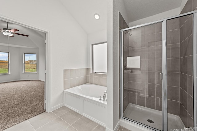 bathroom featuring ceiling fan, lofted ceiling, shower with separate bathtub, and tile patterned flooring