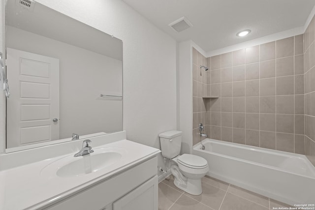 full bathroom featuring tiled shower / bath, vanity, toilet, and tile patterned flooring