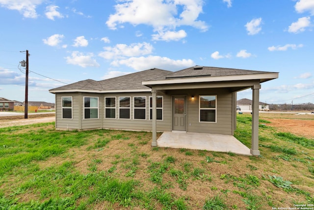 rear view of property featuring a yard and a patio