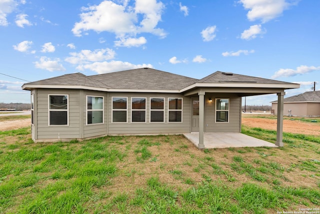 back of property featuring a patio and a lawn