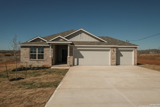 craftsman inspired home with a garage and a front lawn