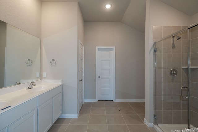 bathroom featuring walk in shower, tile patterned floors, lofted ceiling, and vanity