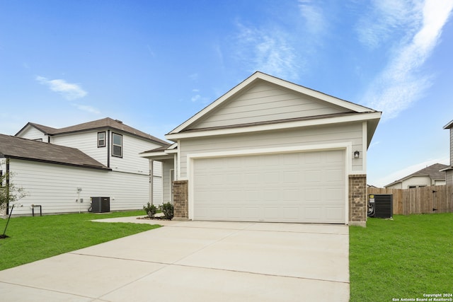 view of front of home with a garage, central air condition unit, and a front lawn