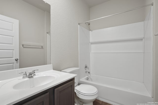 full bathroom with shower / washtub combination, vanity, hardwood / wood-style floors, and toilet