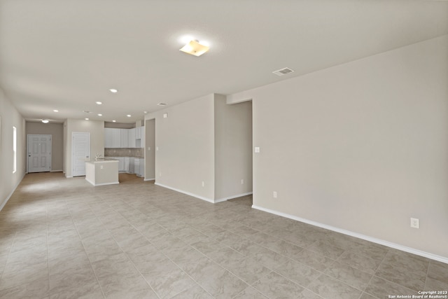 unfurnished living room featuring light tile patterned flooring