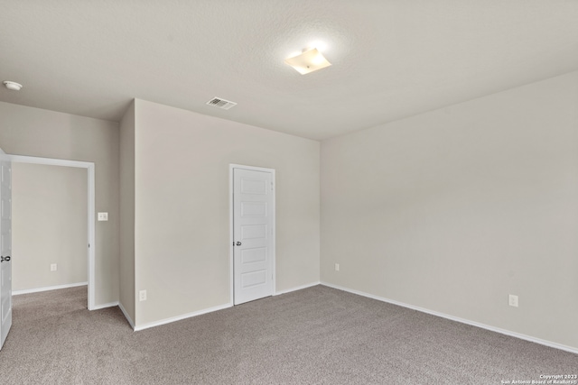 unfurnished bedroom with light carpet and a closet