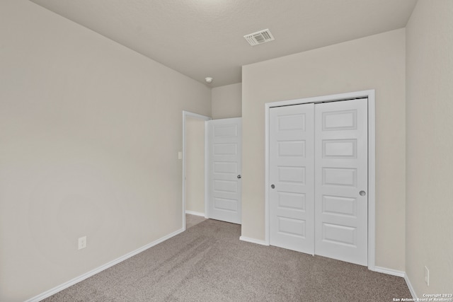 unfurnished bedroom featuring a closet and carpet