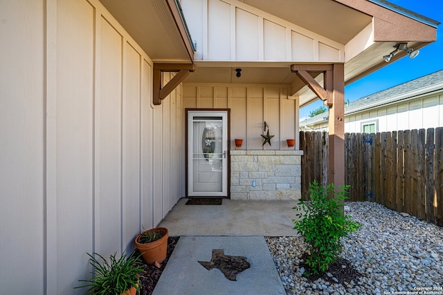 view of exterior entry with a patio