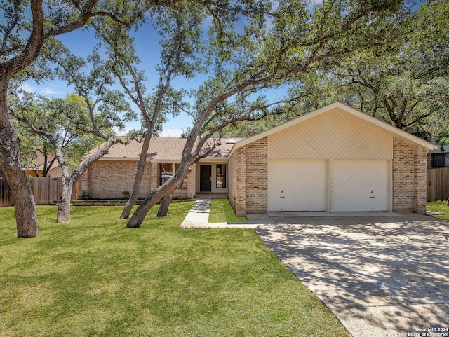 single story home featuring a front lawn and a garage