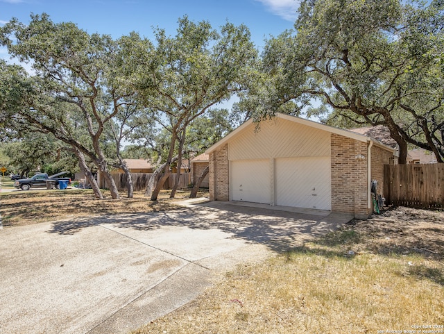 exterior space with a garage and an outbuilding