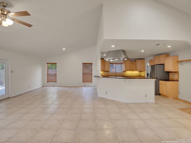 interior space featuring light tile patterned flooring, stainless steel fridge with ice dispenser, decorative backsplash, light brown cabinets, and ceiling fan