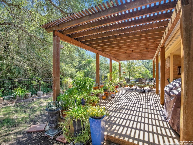 view of patio / terrace featuring a wooden deck and a pergola