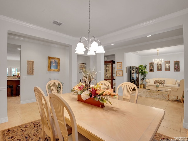 tiled dining room featuring a chandelier and ornamental molding