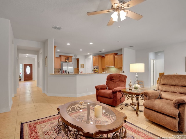 tiled living room with ceiling fan