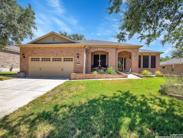 ranch-style home featuring a front yard and a garage