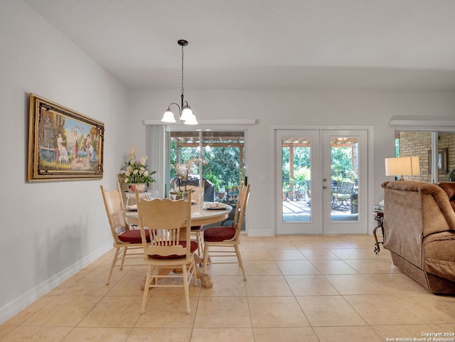 tiled dining area with a chandelier and french doors