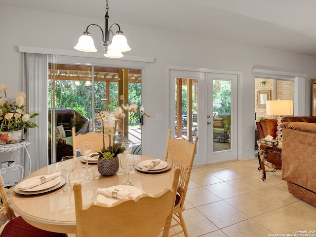 tiled dining space featuring a notable chandelier and french doors