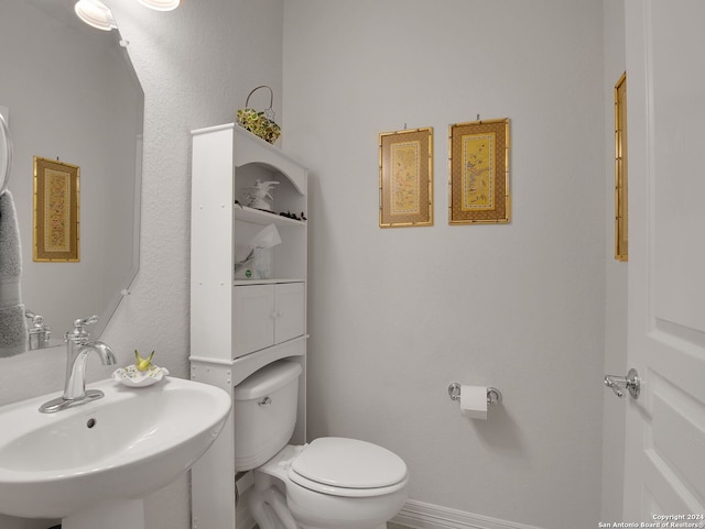 bathroom featuring sink and toilet