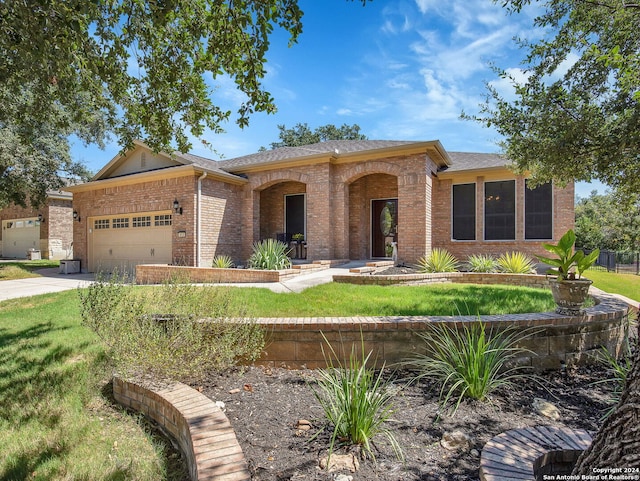 single story home with a garage and a front yard