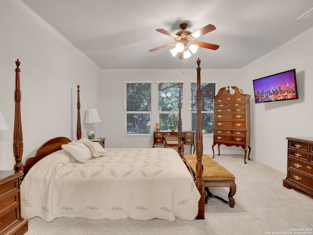 carpeted bedroom with ceiling fan and ornamental molding