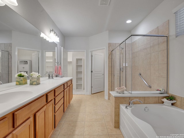 bathroom with independent shower and bath, double vanity, and tile patterned floors