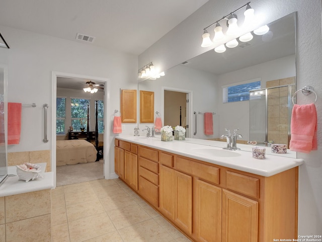 bathroom with tile patterned flooring, ceiling fan, a healthy amount of sunlight, and dual bowl vanity