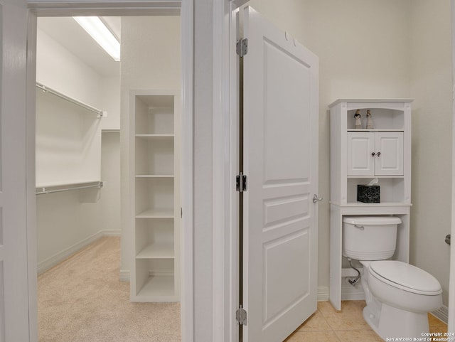 bathroom with toilet and tile patterned flooring