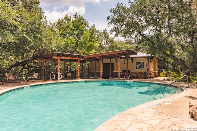 view of pool with a pergola, a patio, and ceiling fan