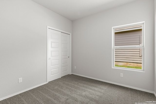 unfurnished bedroom with carpet and a closet