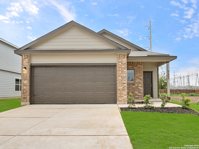 view of front of home featuring a garage and a front lawn