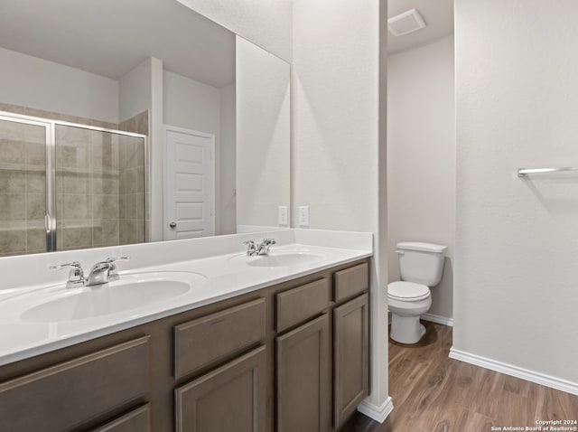 bathroom with toilet, vanity, hardwood / wood-style flooring, and walk in shower