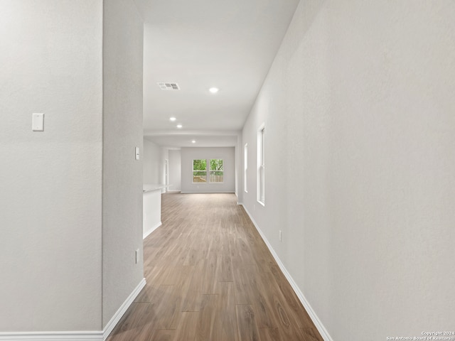 hallway with light hardwood / wood-style floors