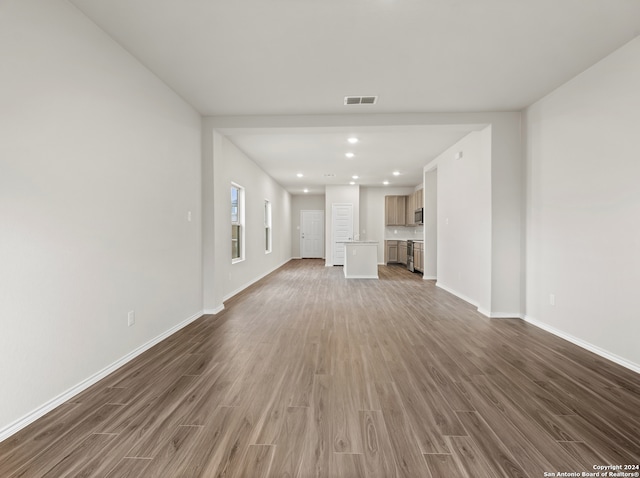 unfurnished living room with dark wood-type flooring