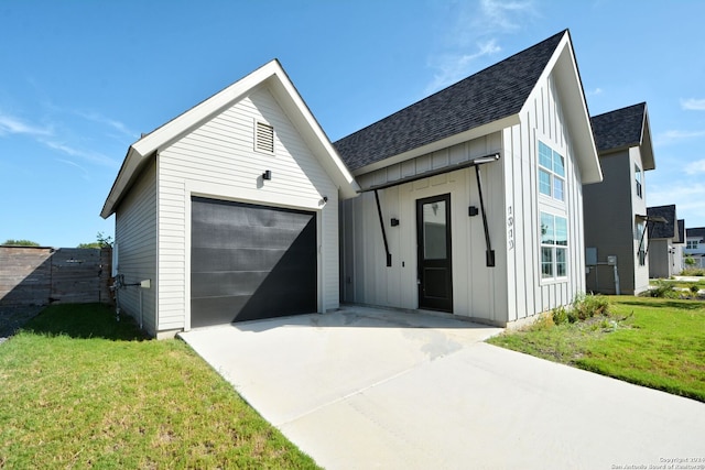 view of front of home featuring a garage and a front lawn