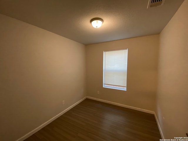 empty room with hardwood / wood-style floors