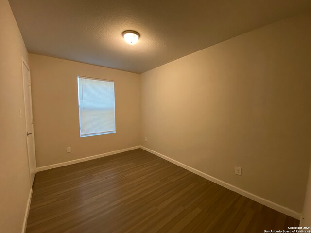 spare room with wood-type flooring