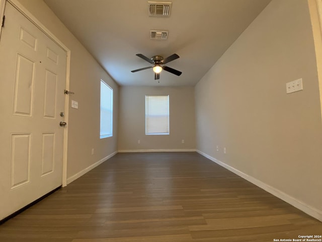 foyer featuring visible vents, baseboards, and dark wood finished floors