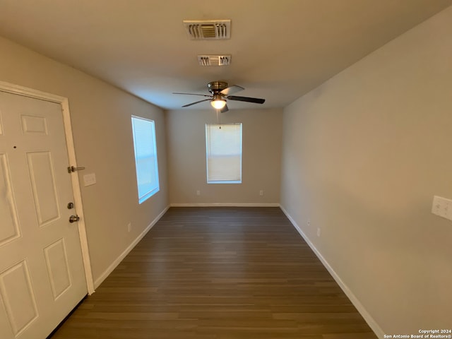 empty room with ceiling fan and hardwood / wood-style floors