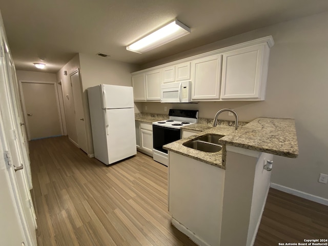 kitchen with sink, light hardwood / wood-style flooring, white appliances, kitchen peninsula, and white cabinets