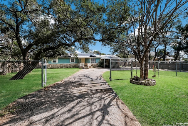 view of front of home with solar panels and a front yard