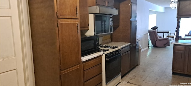 kitchen with pendant lighting and white gas range