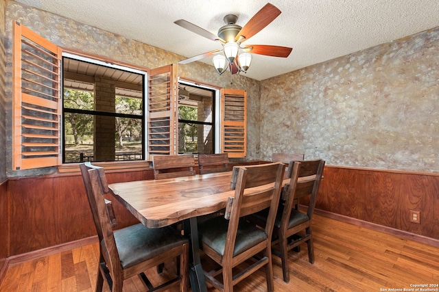 dining room featuring ceiling fan, a textured ceiling, and hardwood / wood-style floors