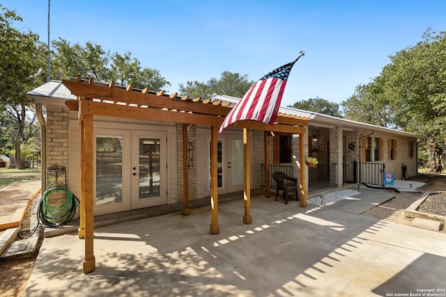 back of property featuring a patio, french doors, and a pergola