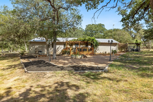 rear view of house with a patio and a lawn