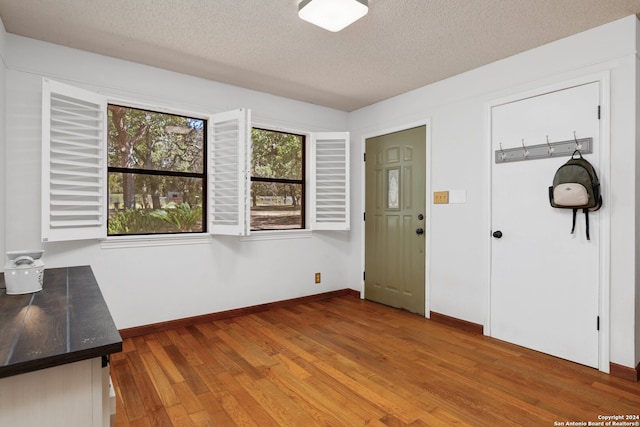 entrance foyer featuring hardwood / wood-style floors and a textured ceiling