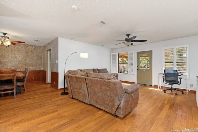 living room with ceiling fan and light hardwood / wood-style floors