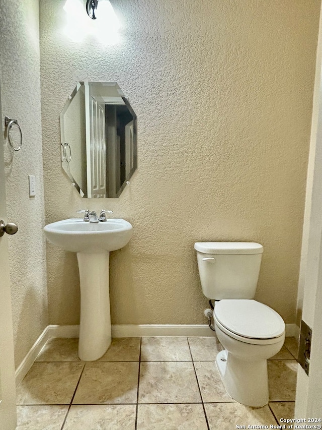 bathroom featuring tile patterned floors and toilet